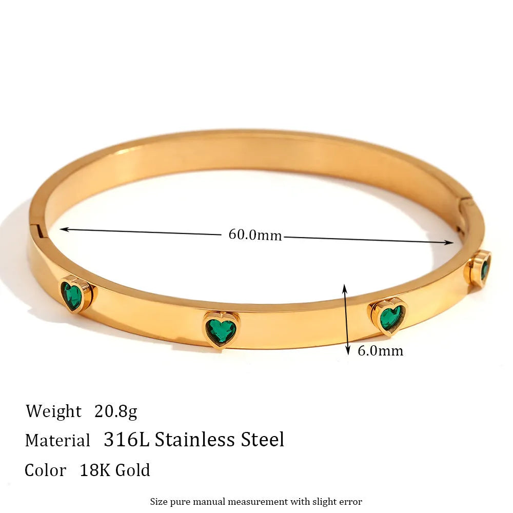 Stainless steel women's bracelet with a small peach heart charm on a simple chain.