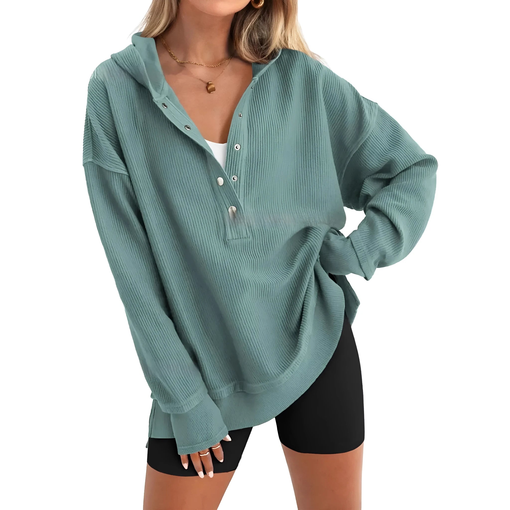 A peacock green loose fit women's jumper with raglan long sleeves on a hanger.