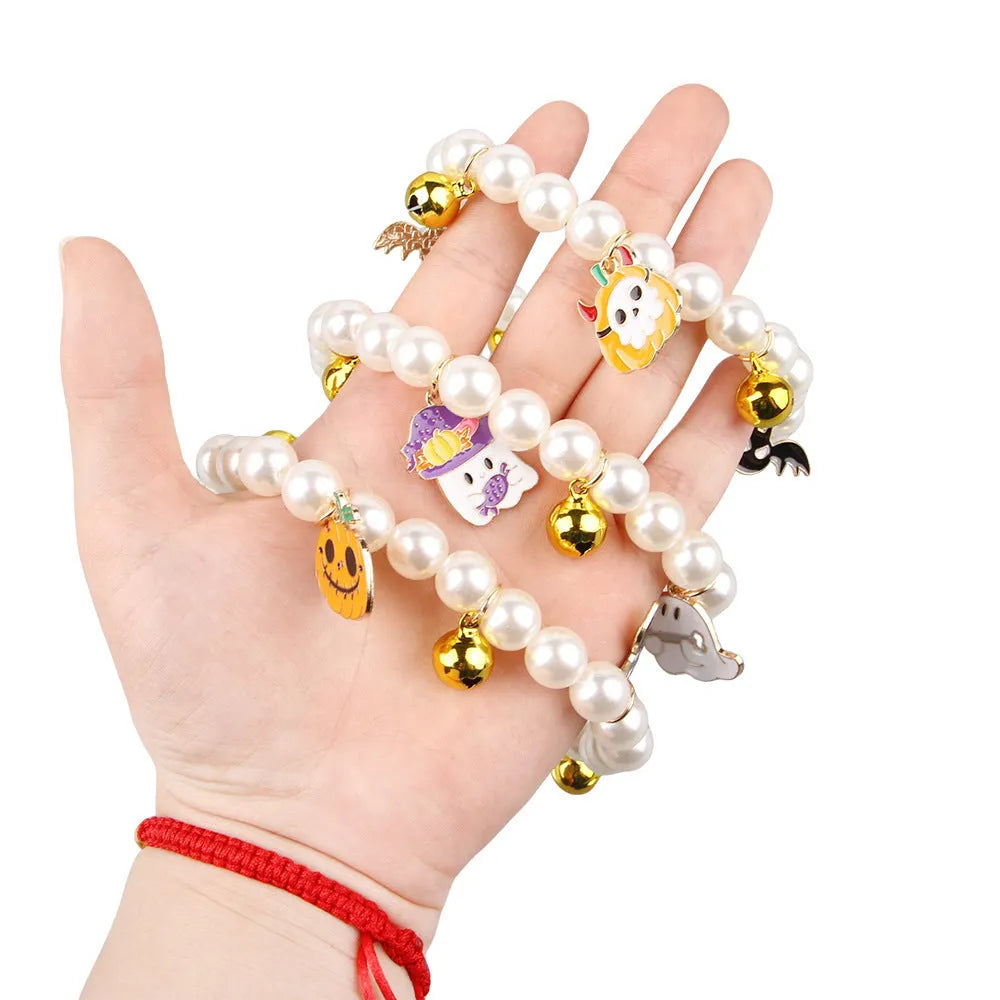 Halloween cat collar with simulated pearls and a choice of purple ghost, skull, or smiling pumpkin print.