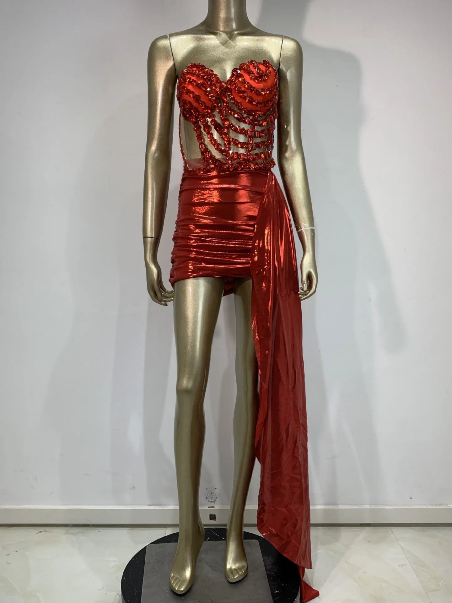 Red women's skirt suit with see-through mesh panels, a stage and party costume in stretch spandex.