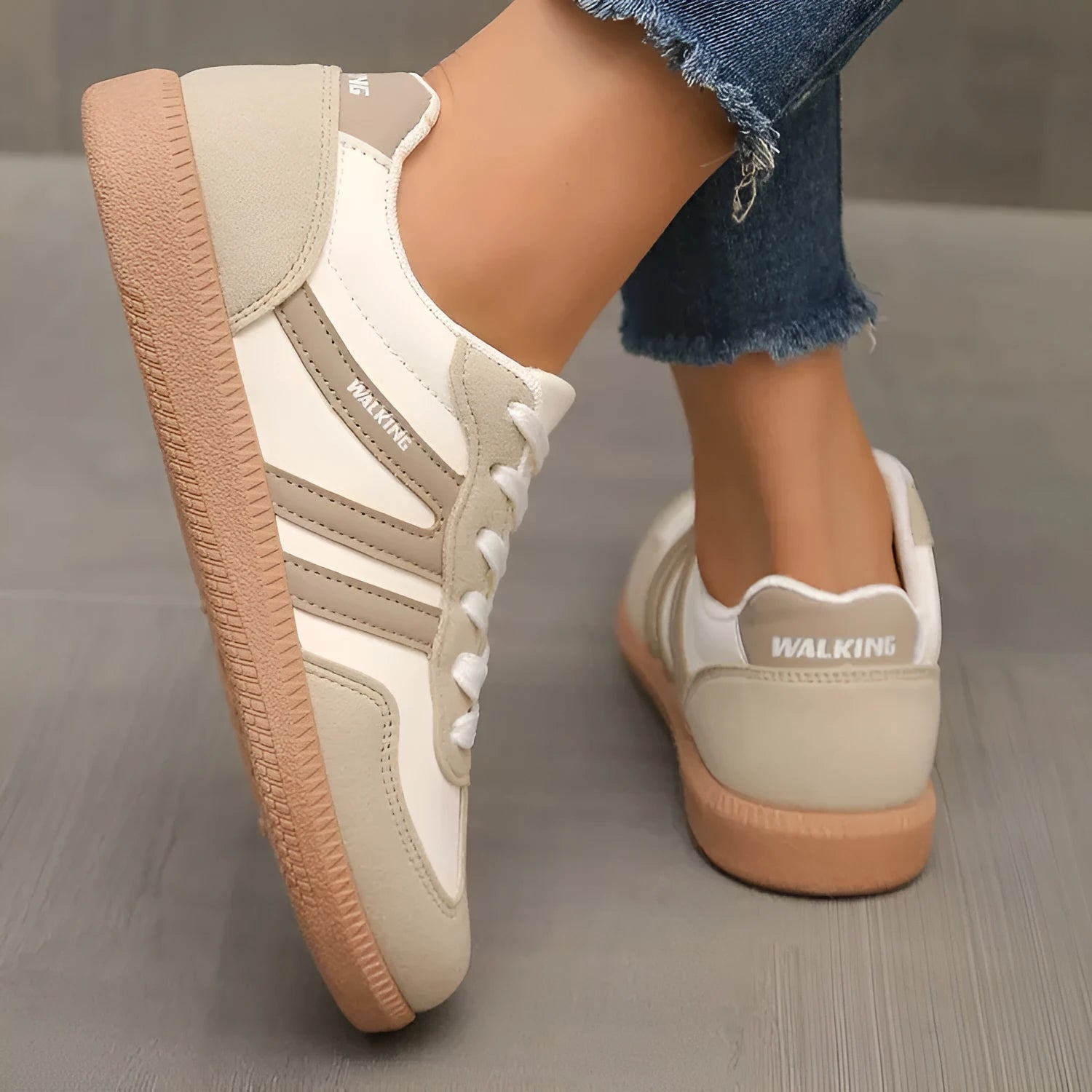 Women's low top casual sneaker in retro style with round toe and lace-up front.