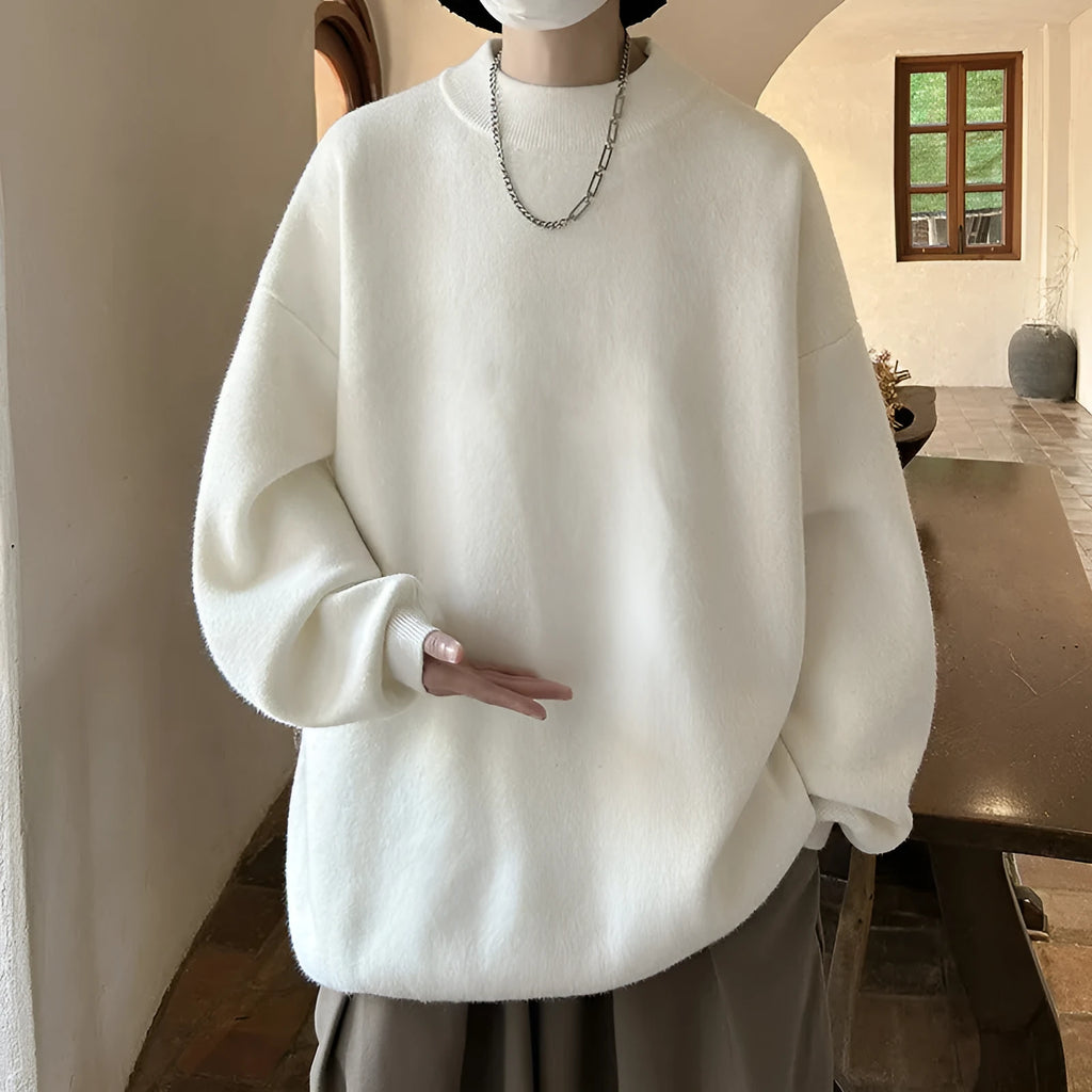 Men's loose fit round neck long sleeve sweater in a solid colour on a hanger.