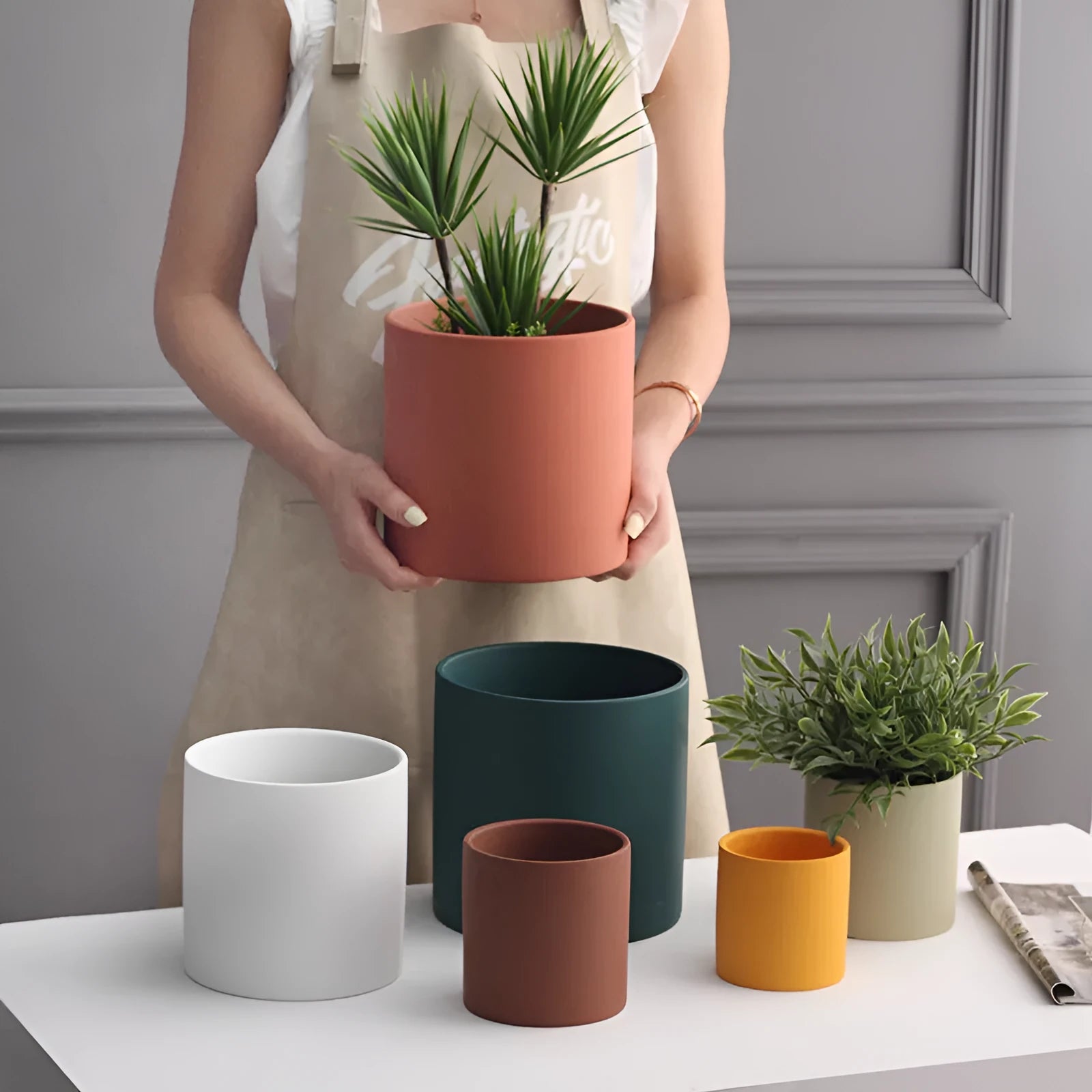 Nordic style cylindrical ceramic cube planter for succulents, shown in a selected colour with visible drainage hole.