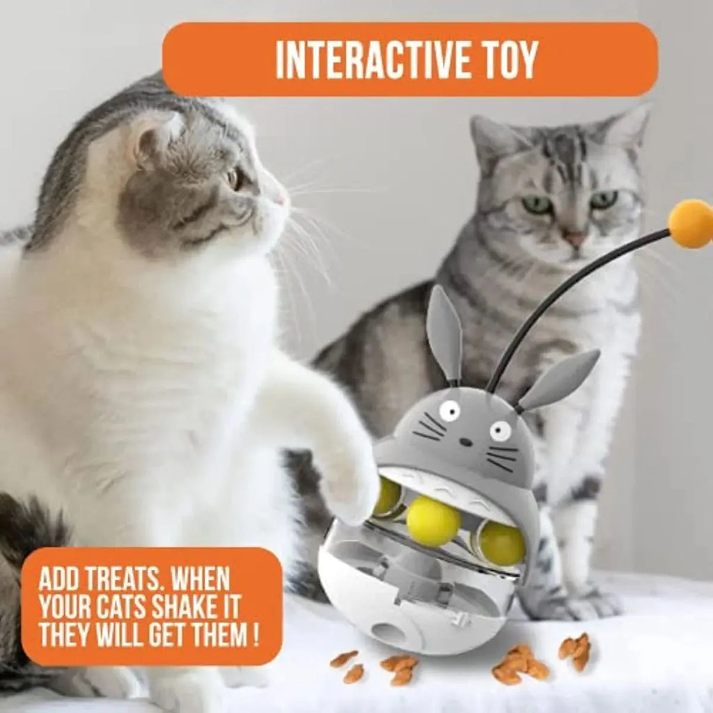 Interactive cat feeder toy with sounding bell and car tower shape in brown, grey, pink, and white