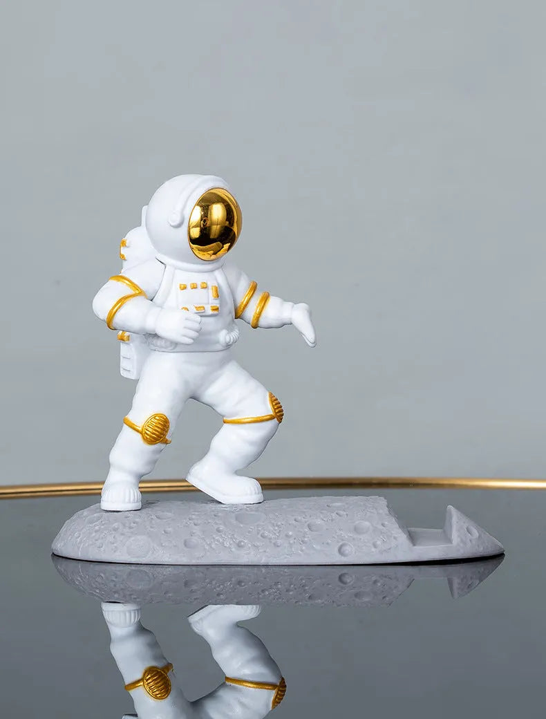 Astronaut decoration spaceman plastic mobile phone holder in blue, gold, and silver colours for lazy binge-watching