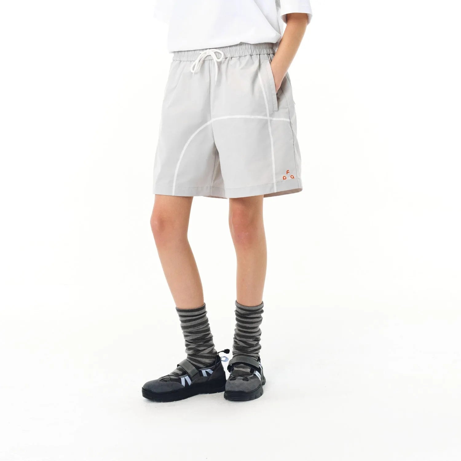 Retro drawstring shorts in polyester fabric showing dark grey, white and apricot colour options