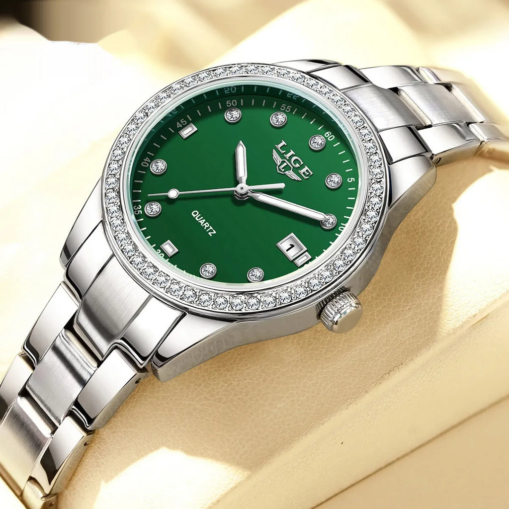 Silver women's fashion watch with diamond bezel, luminous hands on a 34mm round stainless steel dial.