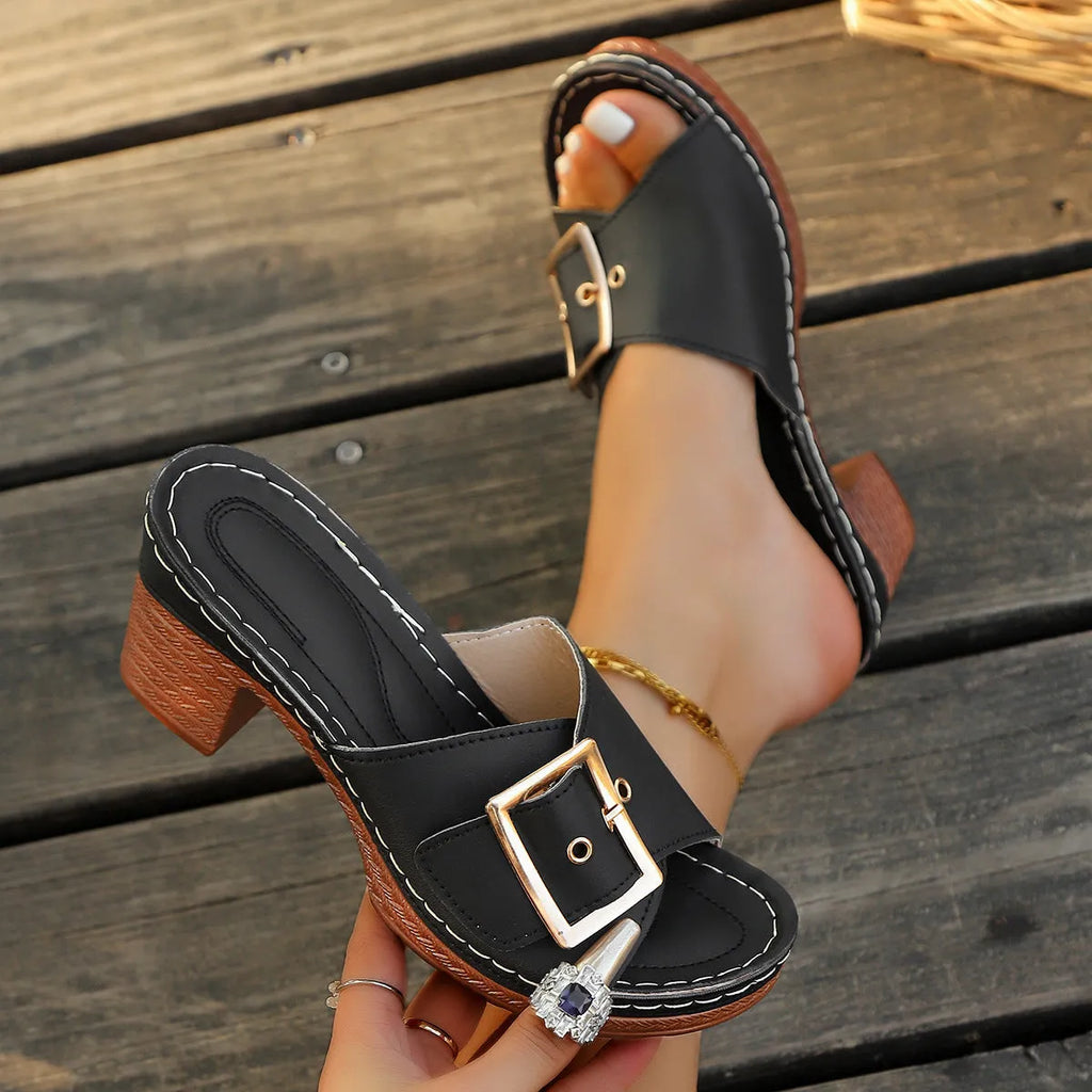Women's black retro chunky heel sandals with a round toe and silver metal buckle on a rubber sole.
