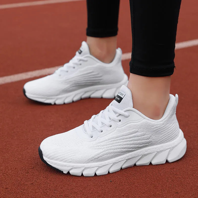 Black and white platform running sneakers with round toe and cross strap details