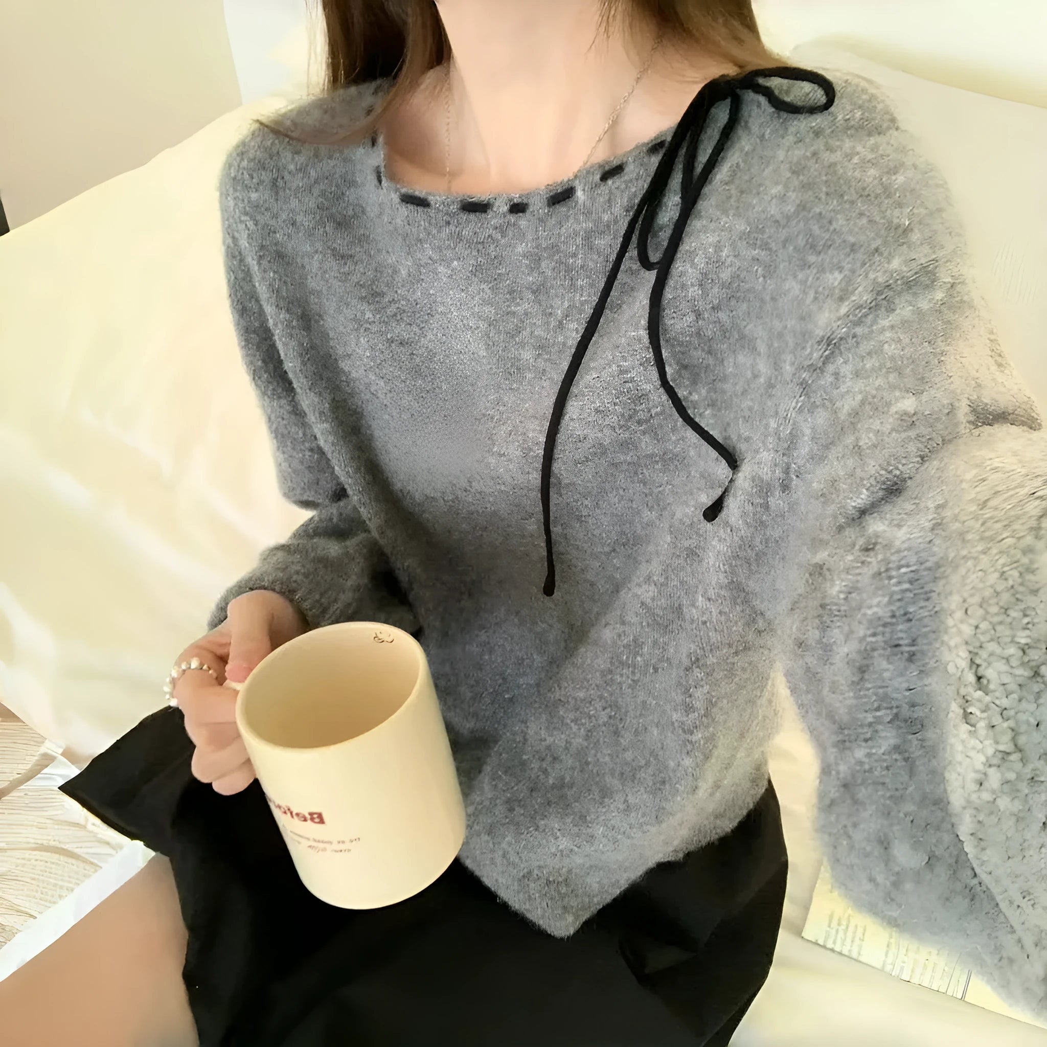 Grey loose-fitting women's long sleeve pullover made from regenerated cellulose knitwear.