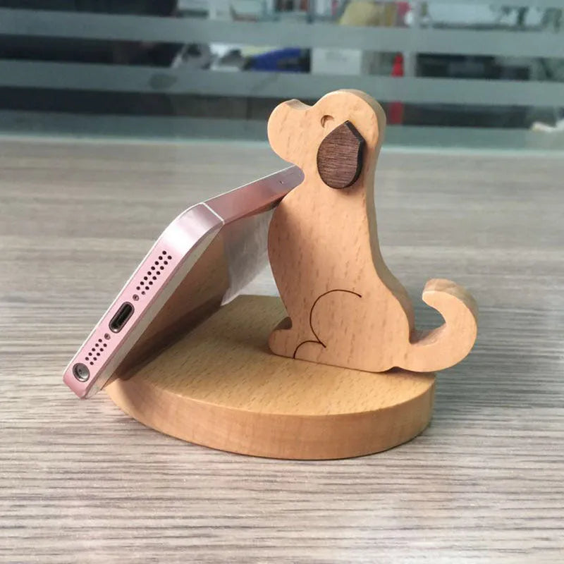 Natural beech wood mobile phone stand with coin slot and custom name engraving on a desk