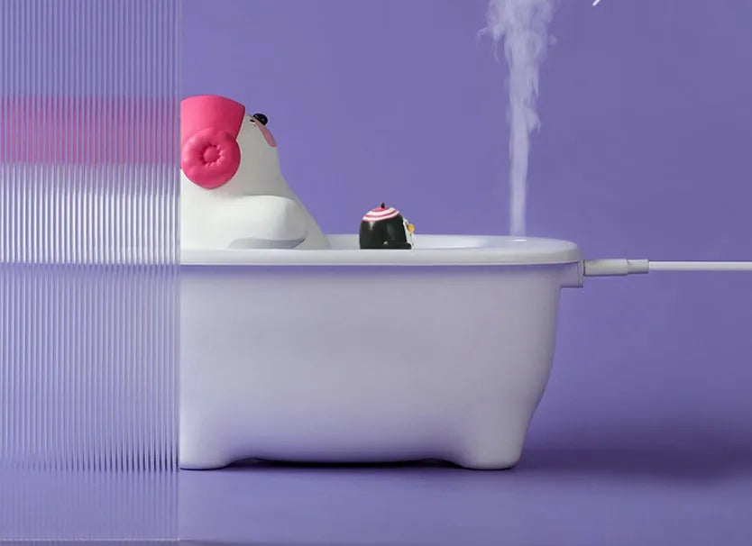 White USB desktop air humidifier with large water tank showing mist output.