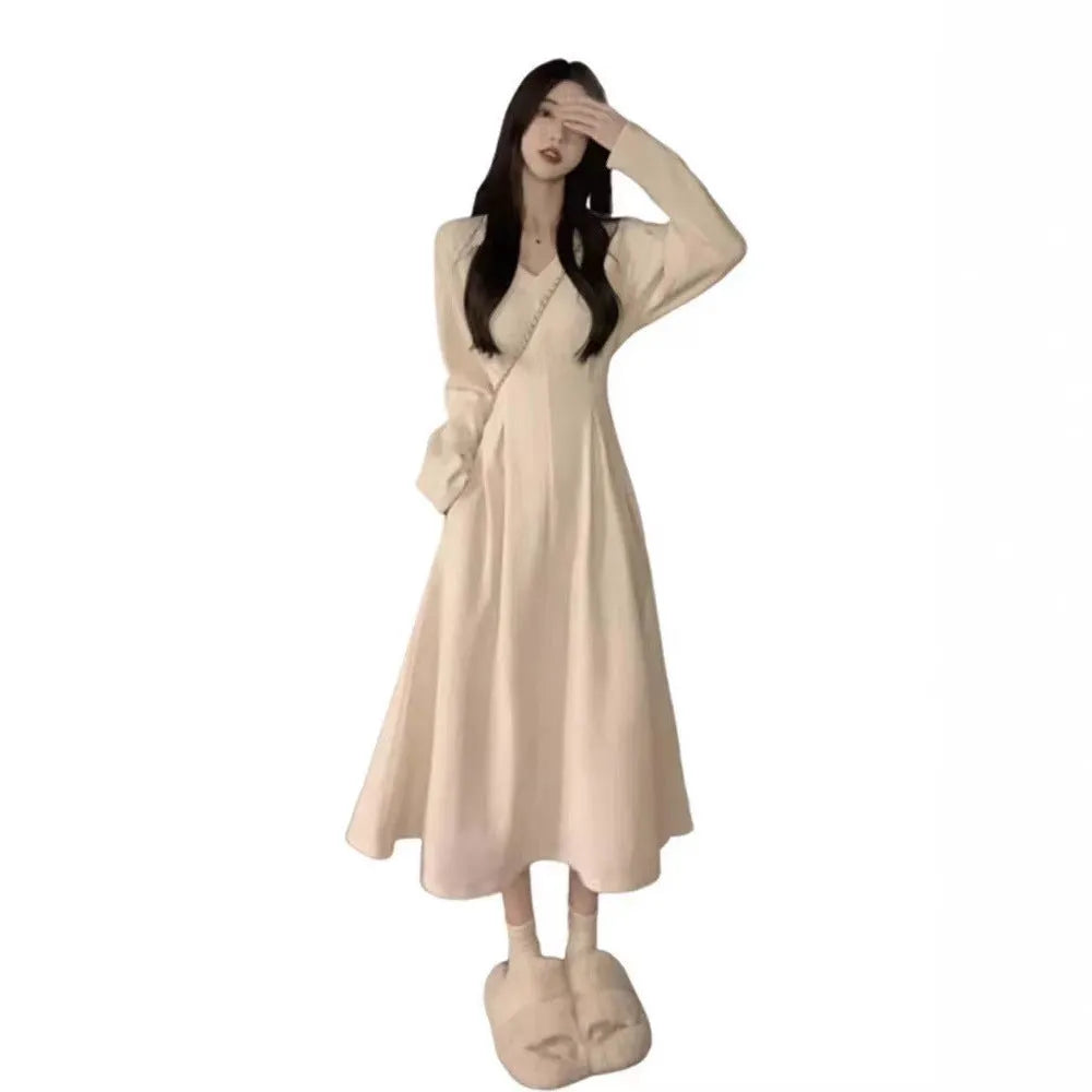 Women's V-neck knitted dress with princess sleeves in milky white colour showing long skirt length