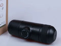 Black portable manual espresso machine showing 6cm diameter and 17.5cm height with stainless steel and plastic components.