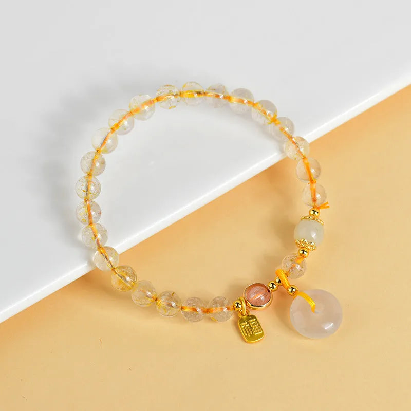 Gold rutilated quartz geometric crystal bracelet with peace buckle safety clasp and pendant charm