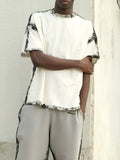 White casual short sleeve top with draped design on a hanger.