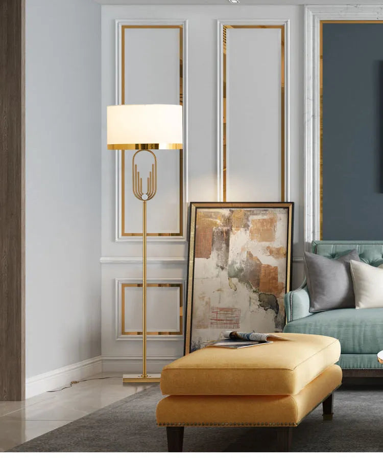 Modern silver floor lamp with adjustable height mechanism and fabric shade, remote control on side table