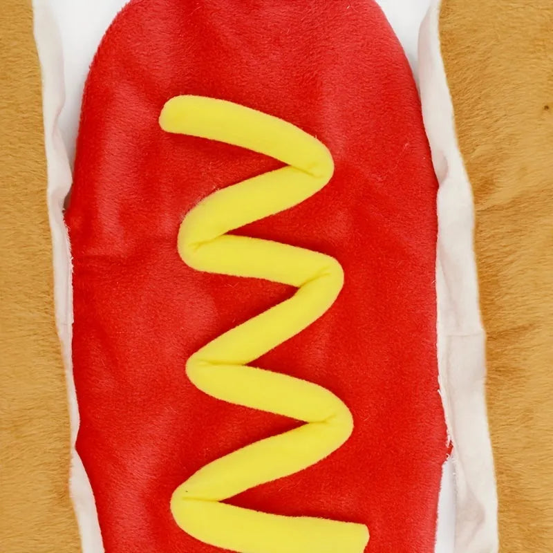 Small dog wearing a funny brown and beige full-body hot dog costume with bun sleeves.