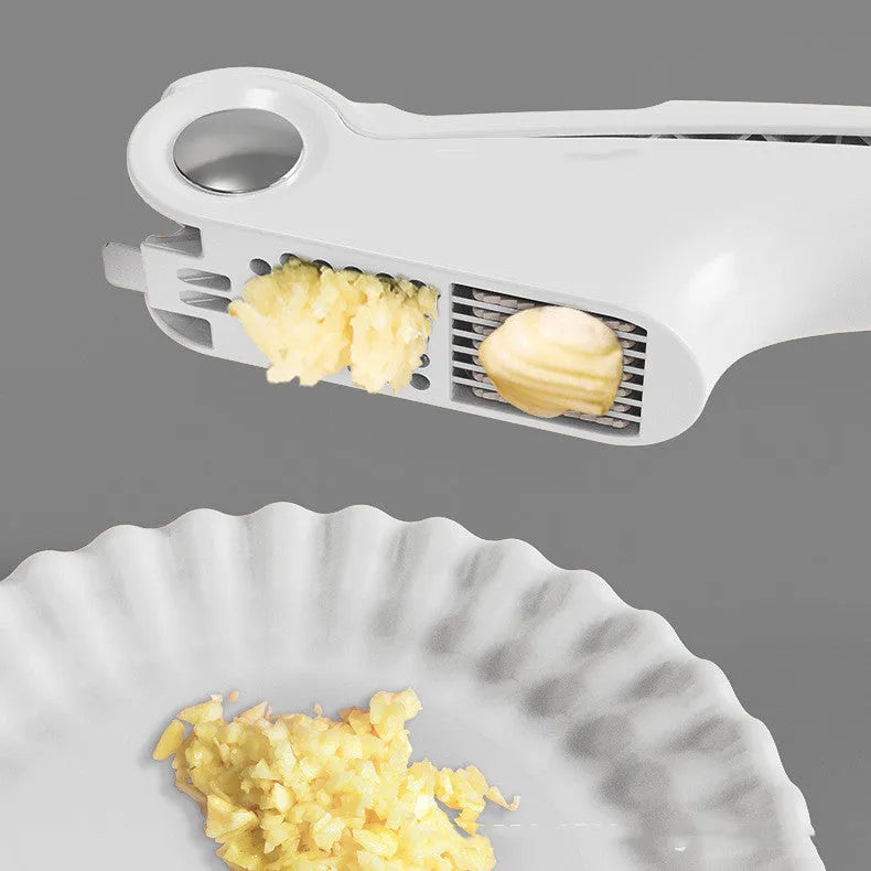 White manual garlic press with stainless steel crusher and ABS plastic handle.