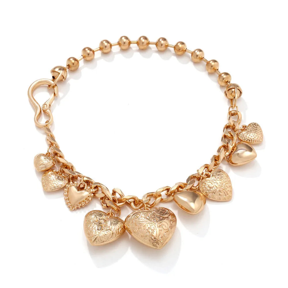Gold-coloured carved heart pendant necklace on an adjustable metal chain.