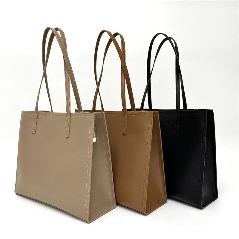 Brown genuine leather women's handbag with single shoulder strap and horizontal square shape