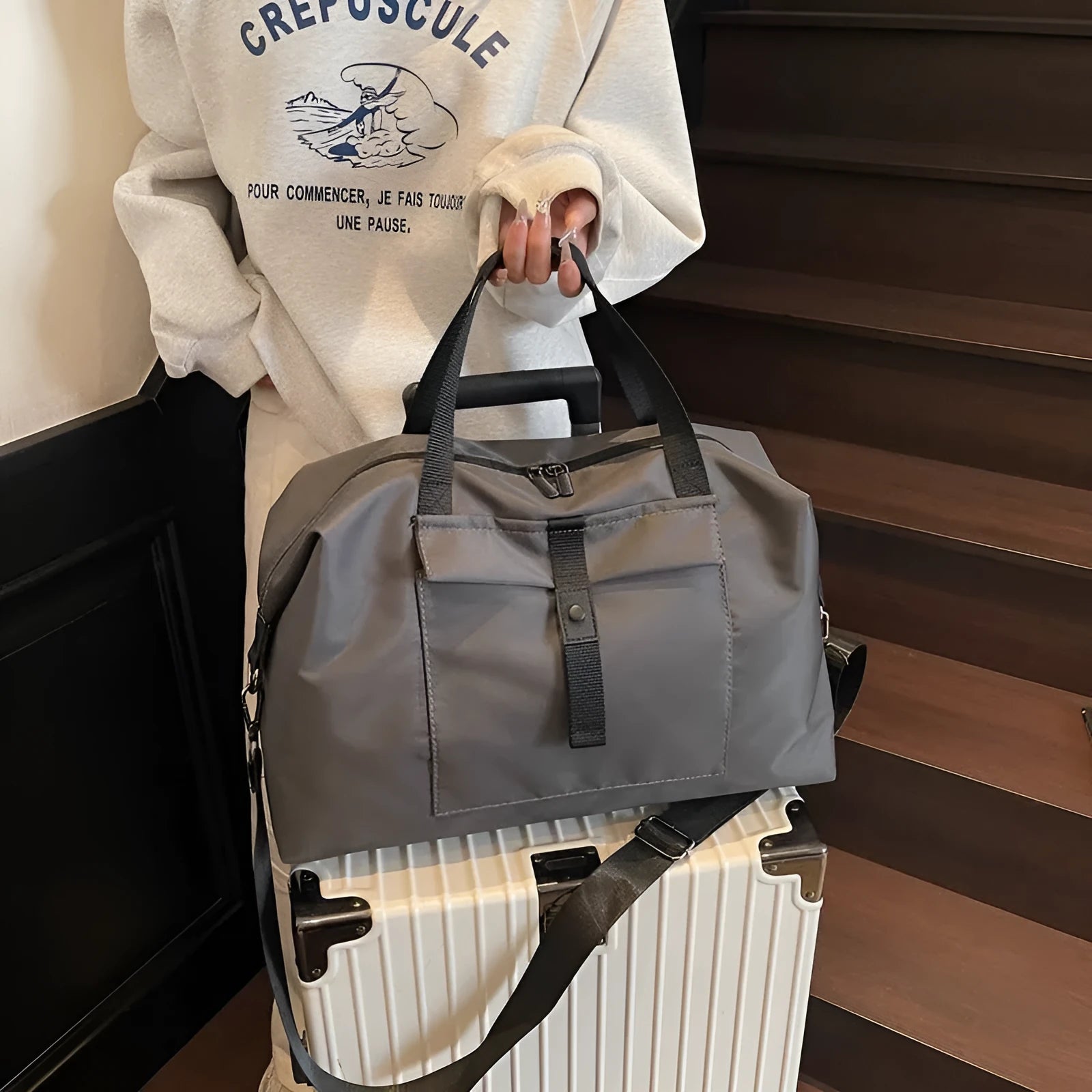 Grey one-shoulder travel backpack with 55 litre capacity showing Oxford cloth construction