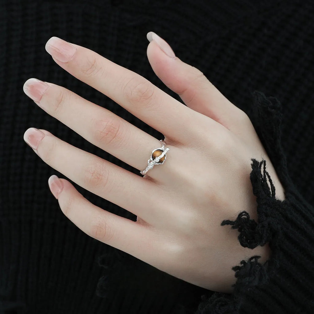 Silver open ring with Saturn design and white gold plating, shown with adjustable opening.