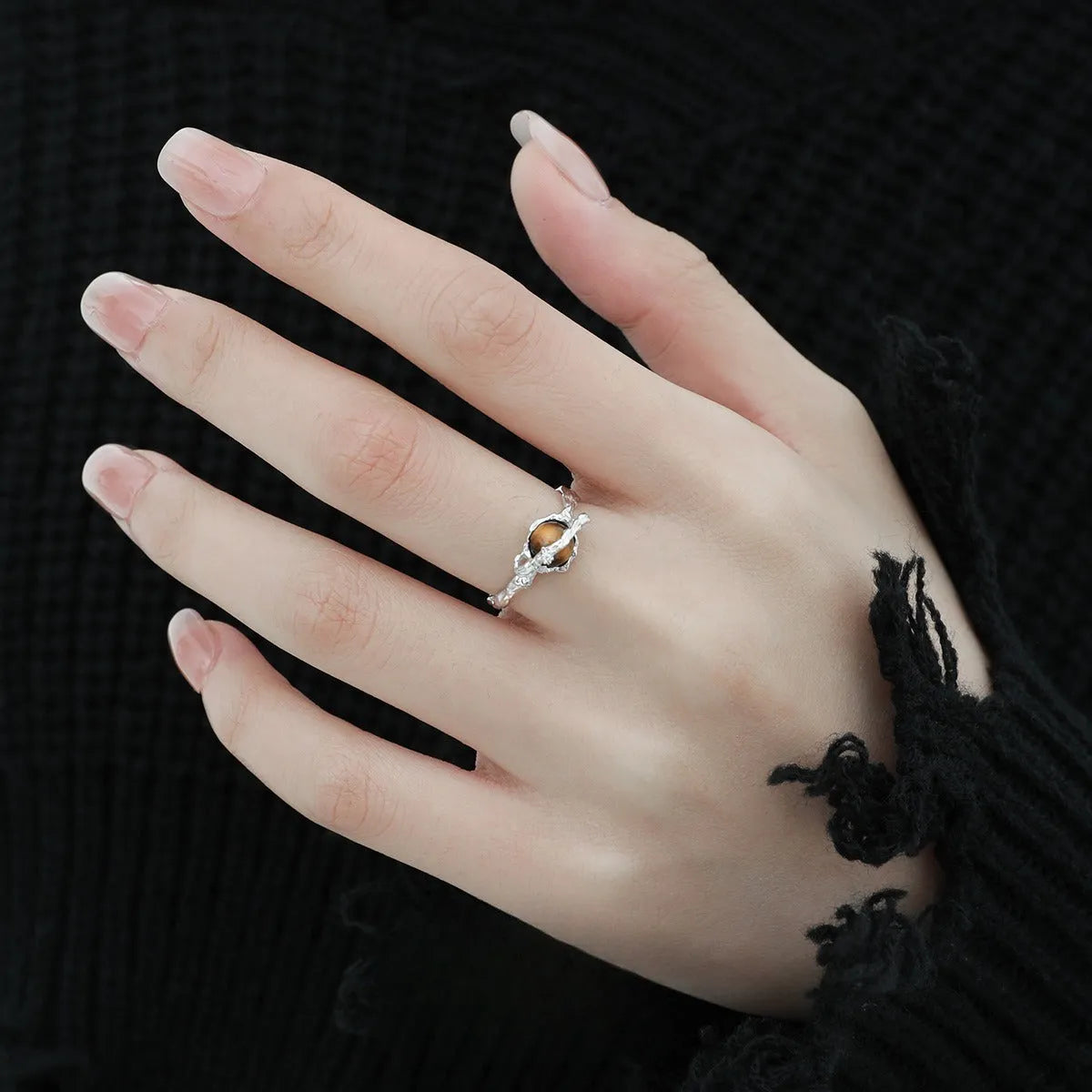 Silver open ring with Saturn design and white gold plating, shown with adjustable opening.