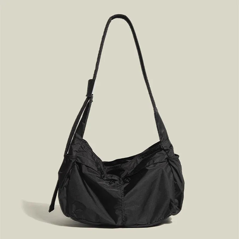 Black nylon waterproof sports style messenger bag with horizontal square design and shoulder strap