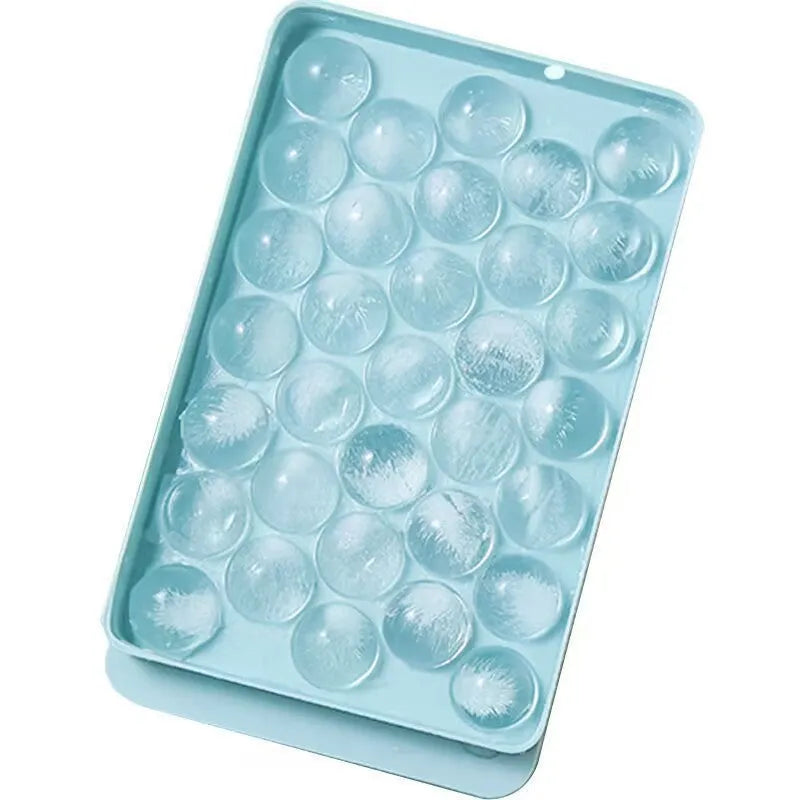 Blue 33-grid round silicone ice cube tray with transparent lid next to pink version, showing dimensions.