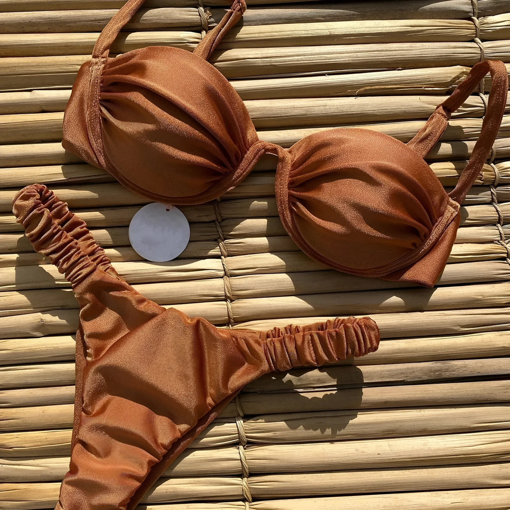 Women's black underwire bikini swimsuit set on a model, showing brief-style fit.