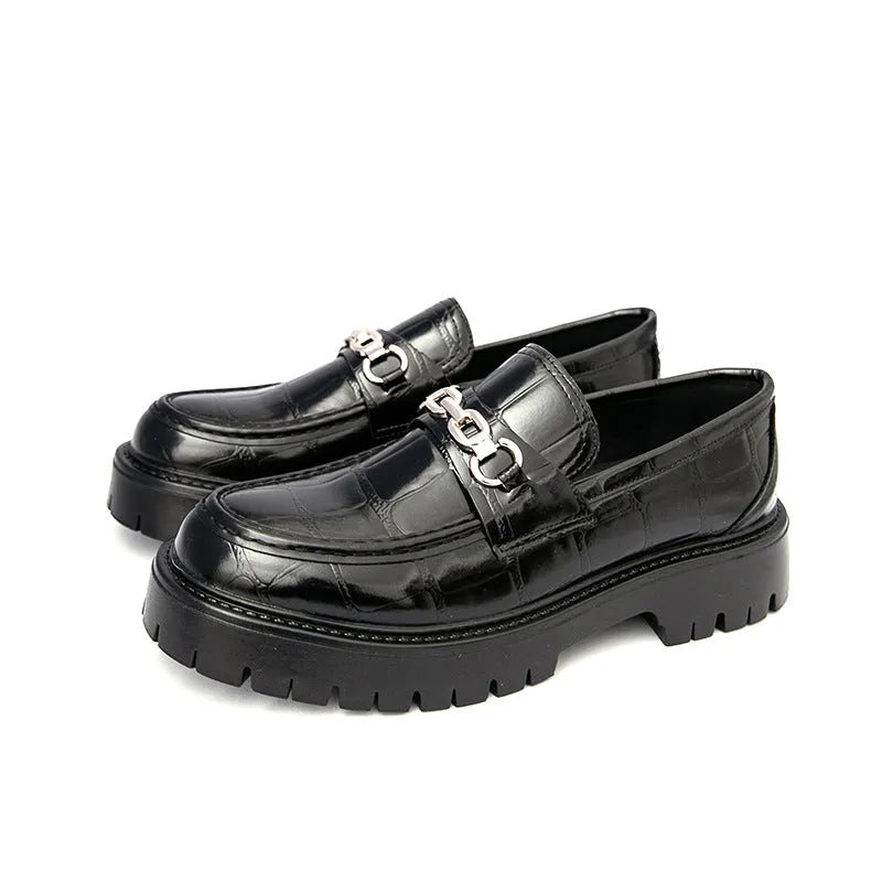 Men's black crocodile pattern leather loafers with a platform sole and flat heel.