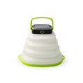Green telescopic LED camping light folded and extended on a table with suction cup
