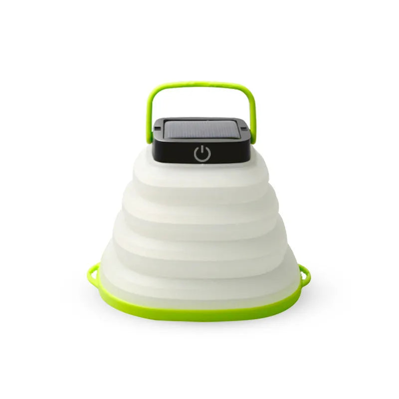 Green telescopic LED camping light folded and extended on a table with suction cup