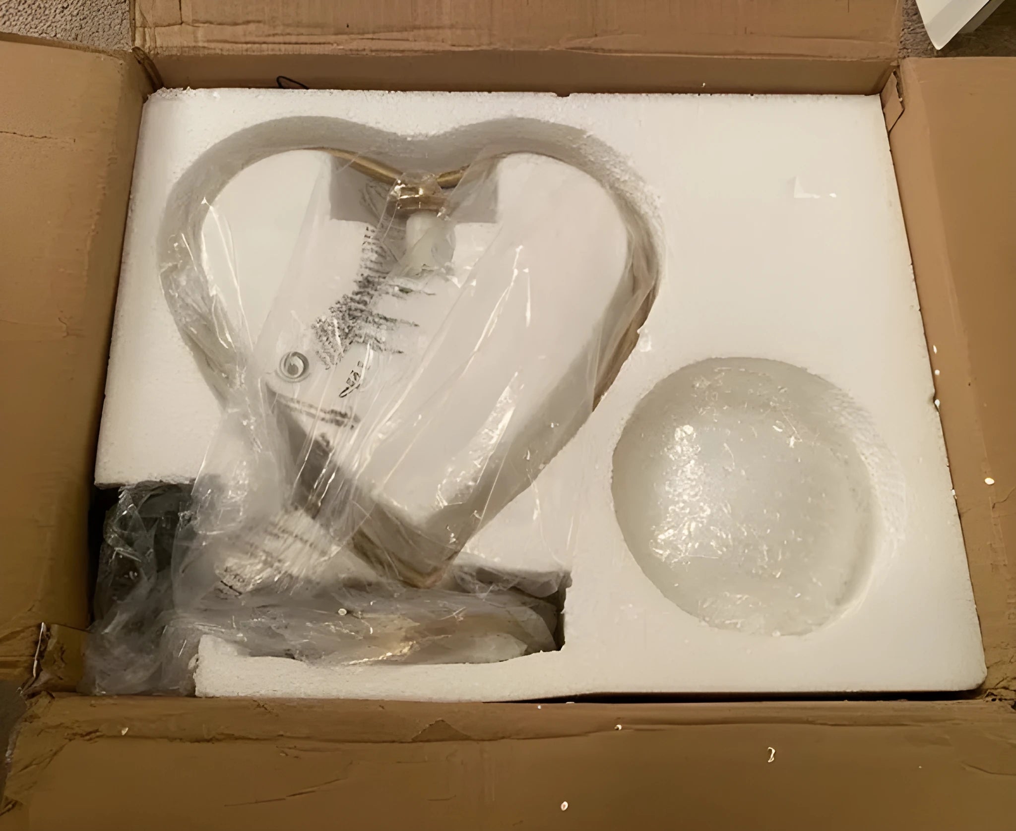 White heart-shaped decorative lamp with warm glow on a table.