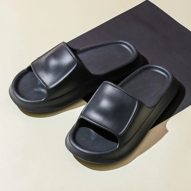 Soft EVA slippers with thick non-slip sole in various colours on a bathroom floor.