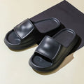 Soft EVA slippers with thick non-slip sole in various colours on a bathroom floor.