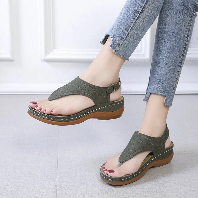 Women's casual wedge heel flip flop sandal in black with adjustable buckle strap.