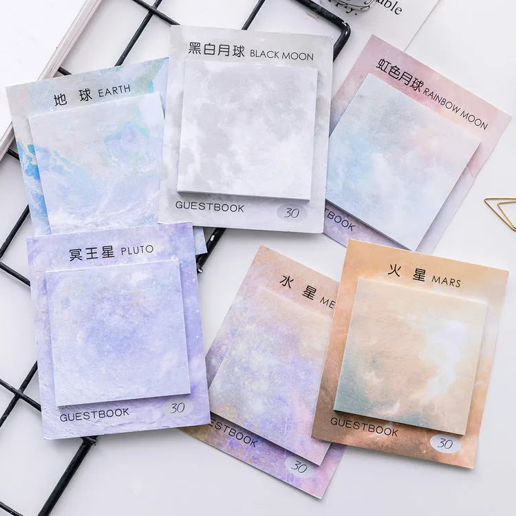 Square planet sticky note pad showing oil painting designs of Earth and other planets.