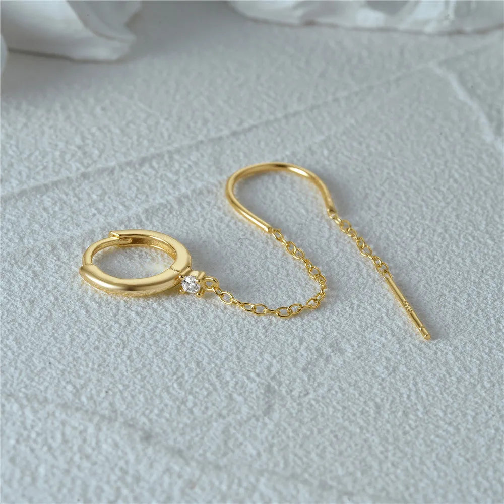 S925 sterling silver geometric stud earrings with diamond, flower, and tassel chain design in a golden colour.