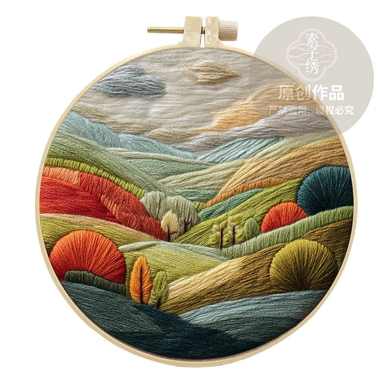 Embroidery DIY kit with landscape-printed cotton fabric, embroidery threads, and needles for handmade cloth art