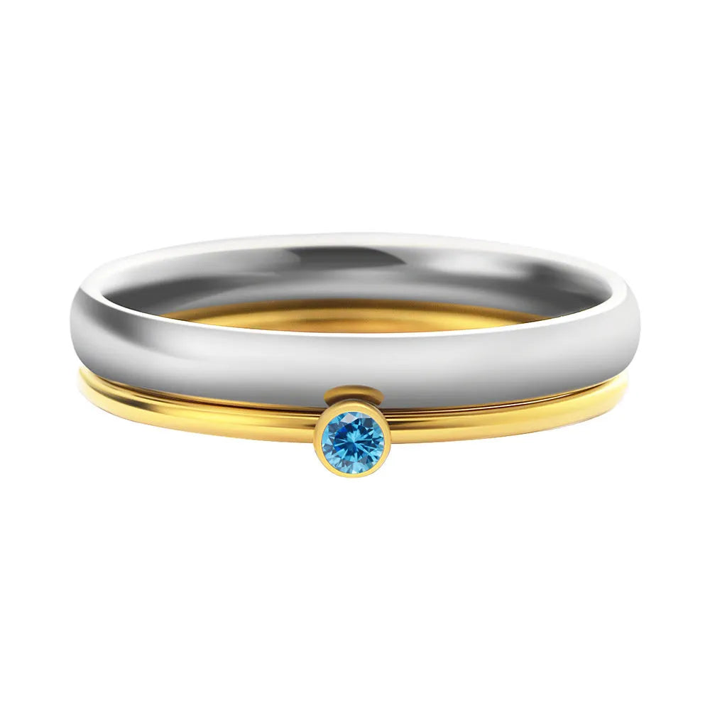 Gold tone titanium steel ring with a December birthstone in an engraved geometric design.