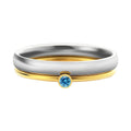 Gold tone titanium steel ring with a December birthstone in an engraved geometric design.