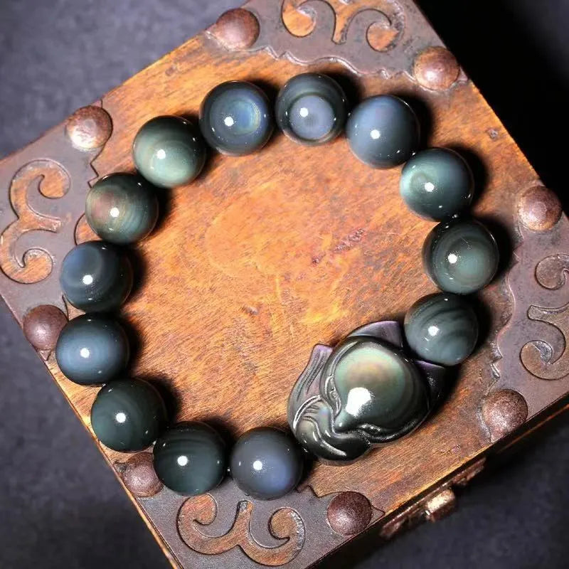 Obsidian stone bracelet with carved fox design in cartoon style, showing bead size options.