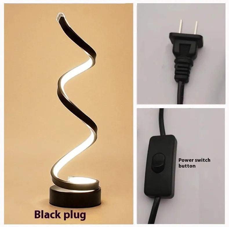 Minimalist black LED table lamp with aluminium shade on wooden desk