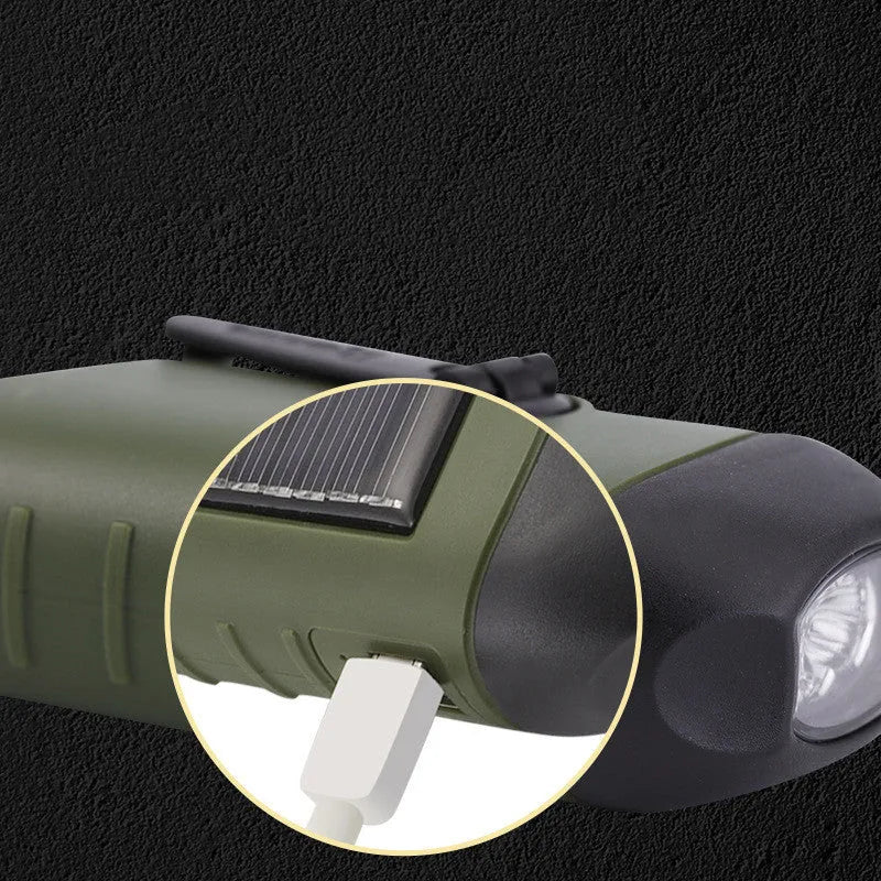Hand-crank and solar powered olive green LED flashlight with USB charging port.