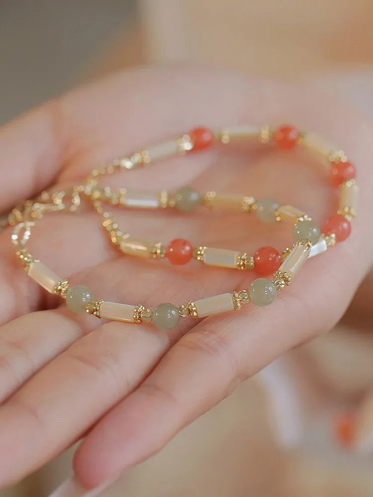 Women's green Hetian jade bracelet with a bamboo joint design.