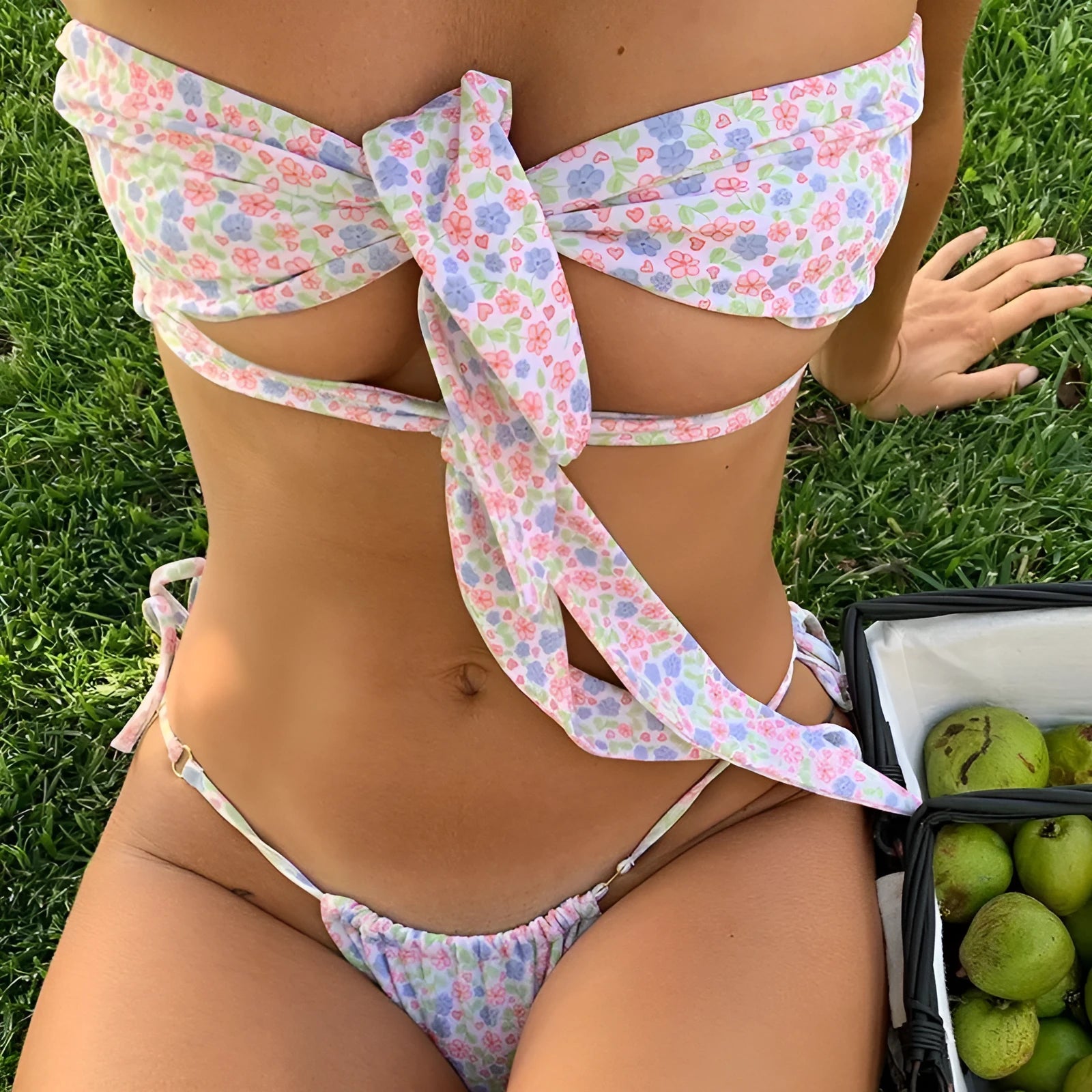 Women's lace-up front swimsuit with wireless chest pad in a floral print, showing high-leg split briefs design.