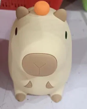 Cute capybara-shaped small night lamp on a table, showing its size and design.