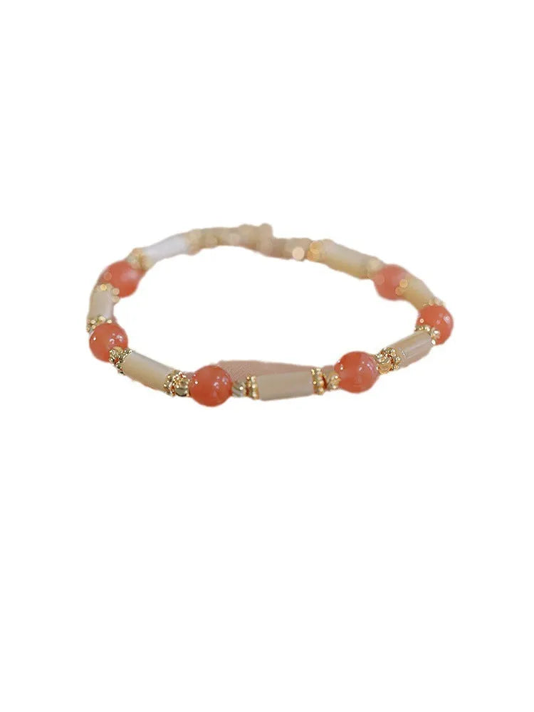 Women's green Hetian jade bracelet with a bamboo joint design.